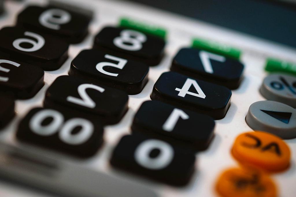 Financial adviser reviewing a household budget with a couple at a table
